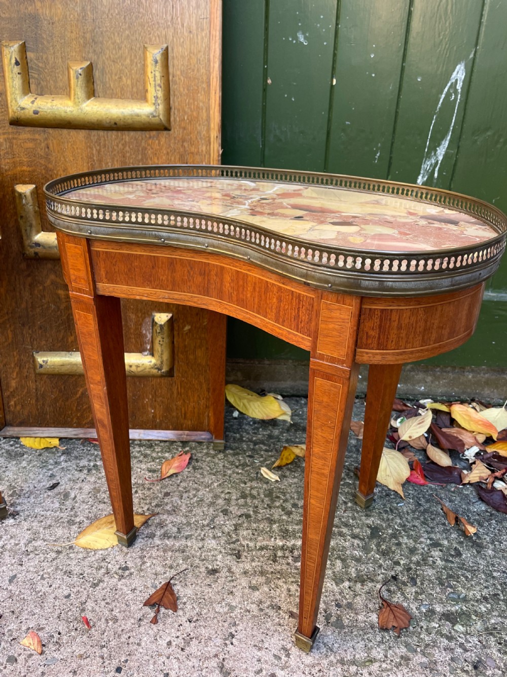 A pair of early twentieth-century French kidney-shaped side tables made from walnut and kingwood with brass galleried marble tops and tapered legs. View IV