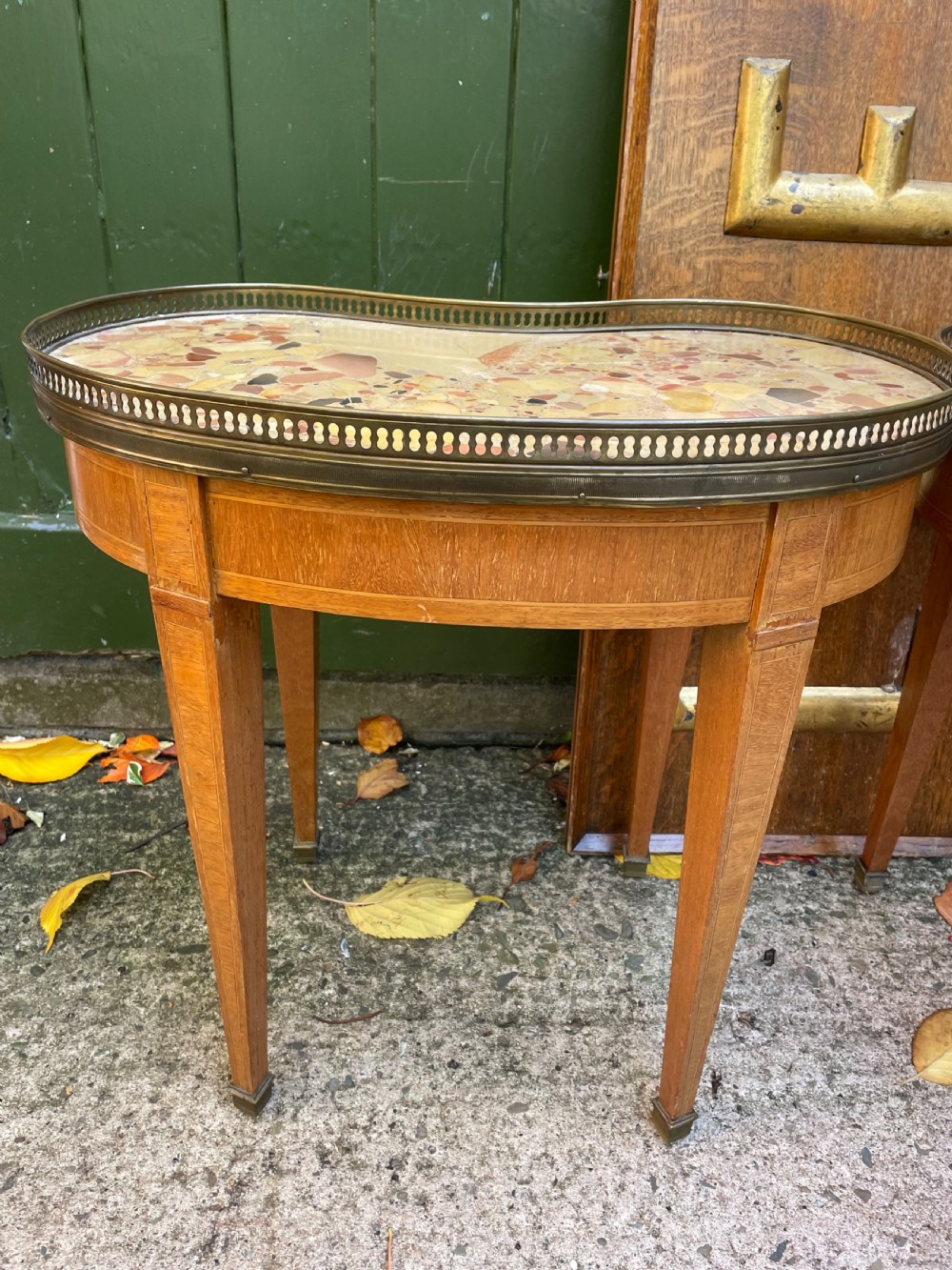 A pair of early twentieth-century French kidney-shaped side tables made from walnut and kingwood with brass galleried marble tops and tapered legs. View VIII
