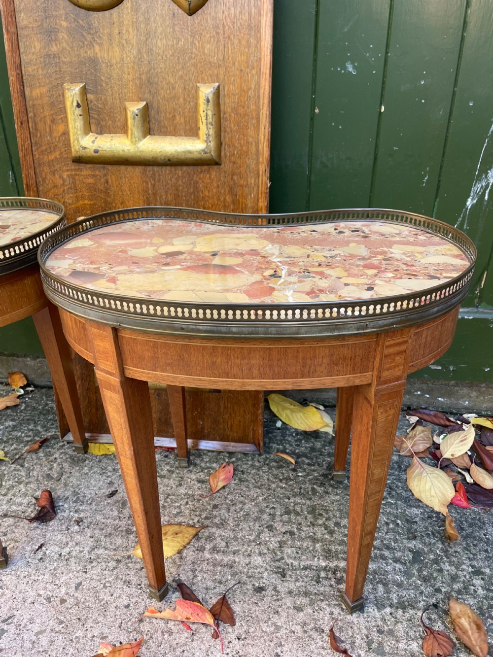 A pair of early twentieth-century French kidney-shaped side tables made from walnut and kingwood with brass galleried marble tops and tapered legs. View IX