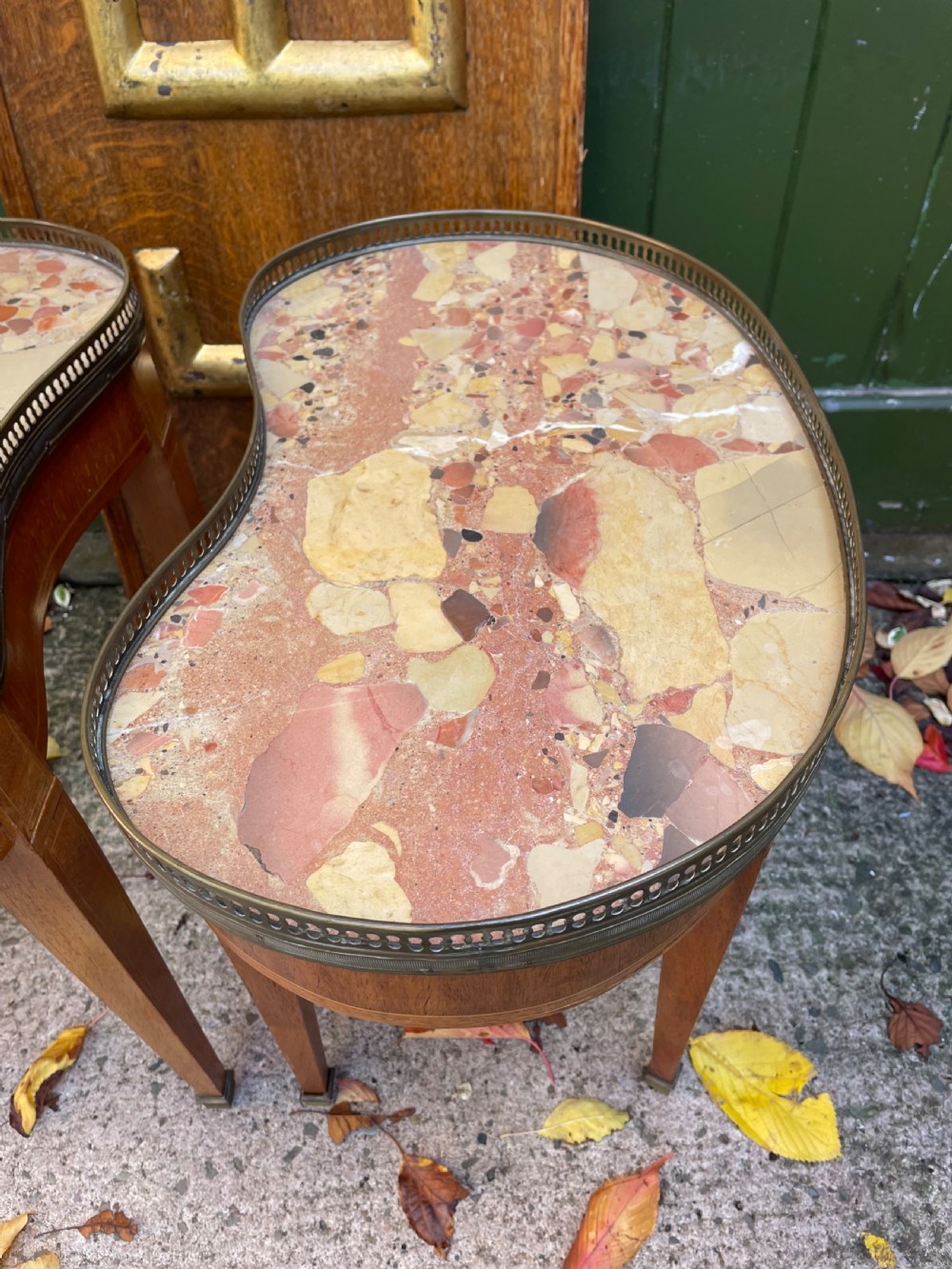 A pair of early twentieth-century French kidney-shaped side tables made from walnut and kingwood with brass galleried marble tops and tapered legs. View XV