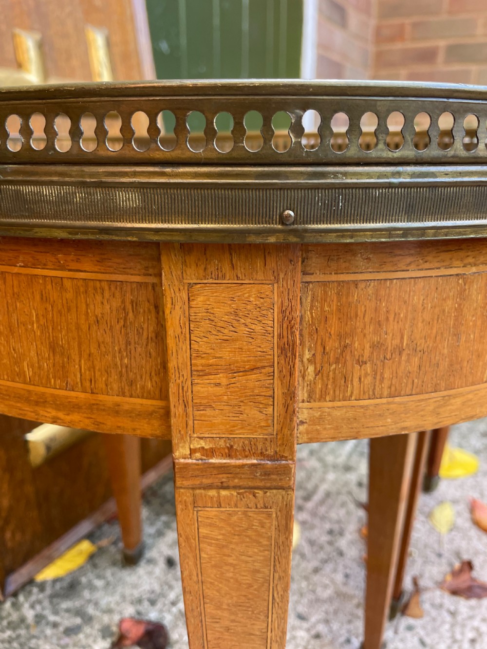A pair of early twentieth-century French kidney-shaped side tables made from walnut and kingwood with brass galleried marble tops and tapered legs. View XIX