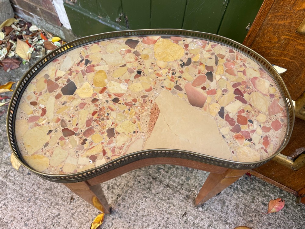 A pair of early twentieth-century French kidney-shaped side tables made from walnut and kingwood with brass galleried marble tops and tapered legs. View V