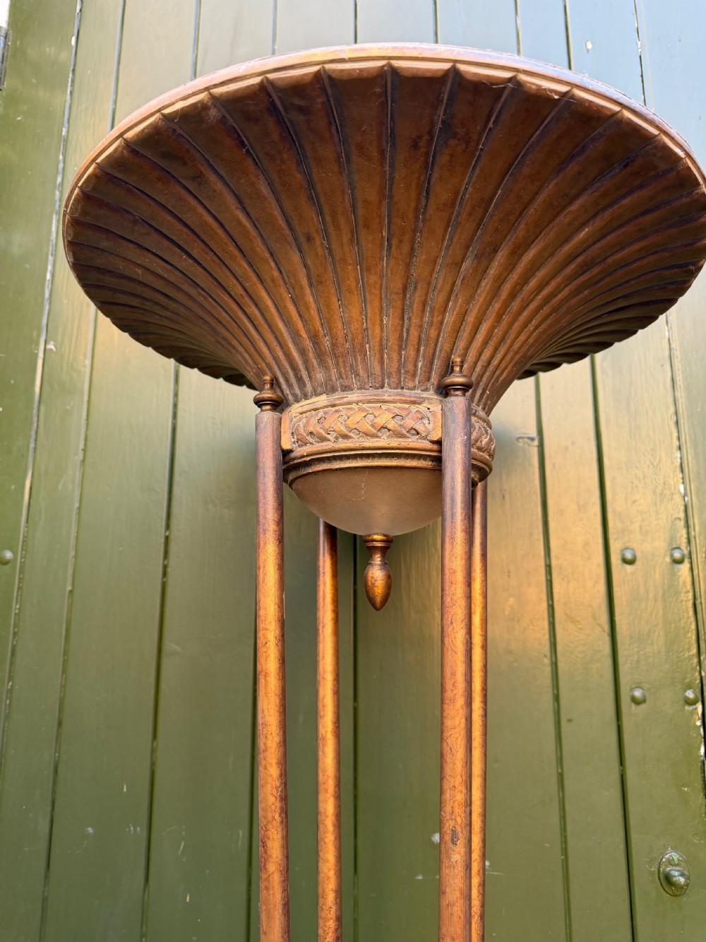 A pair of early 20th-century gilt metal torchiere floor lamps featuring fluted inverted cone shades and slender multi-stemmed stands supported by textured circular bases. View II