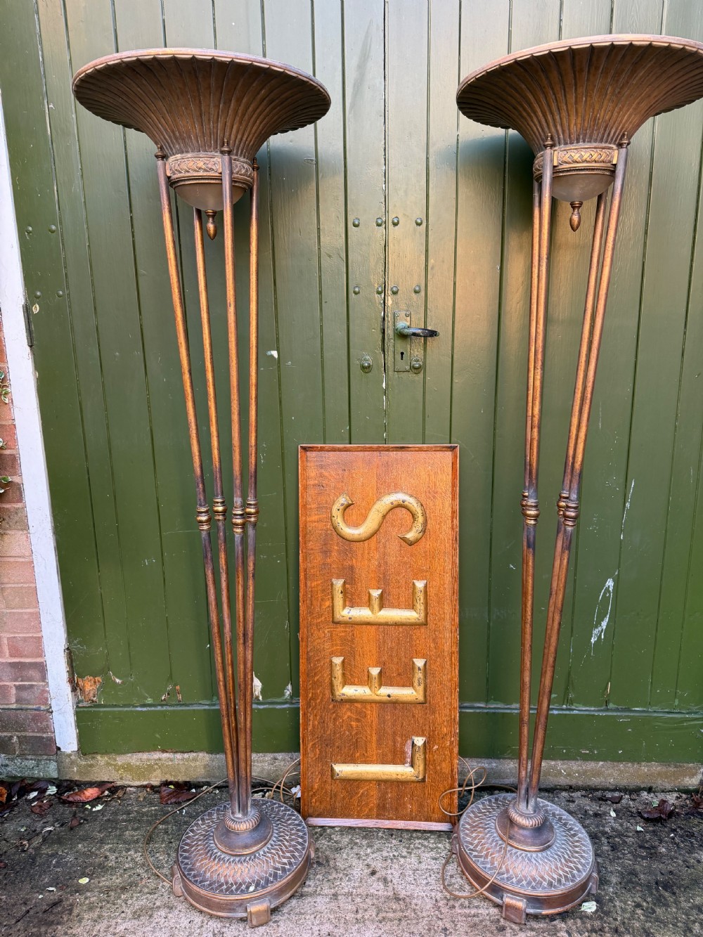 A pair of early 20th-century gilt metal torchiere floor lamps featuring fluted inverted cone shades and slender multi-stemmed stands supported by textured circular bases. View V