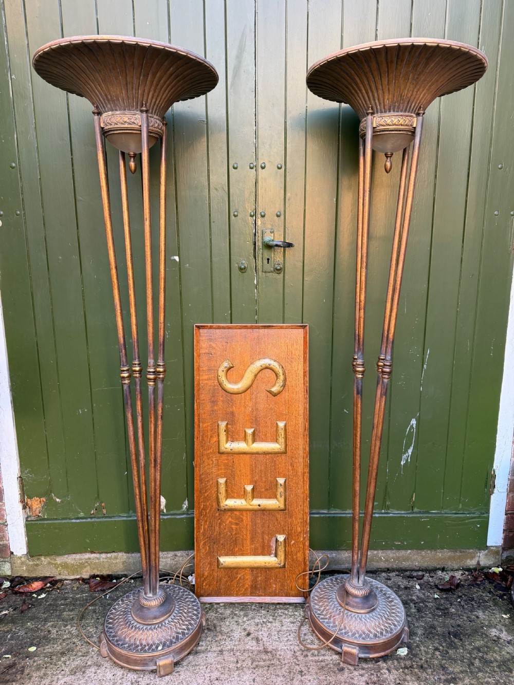 A pair of early 20th-century gilt metal torchiere floor lamps featuring fluted inverted cone shades and slender multi-stemmed stands supported by textured circular bases. View VII