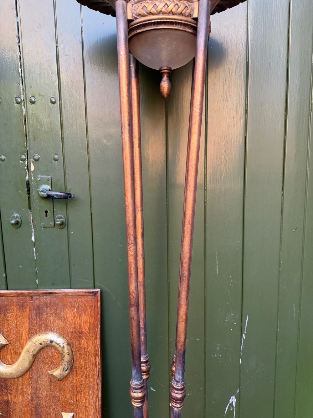 A pair of early 20th-century gilt metal torchiere floor lamps featuring fluted inverted cone shades and slender multi-stemmed stands supported by textured circular bases. View X