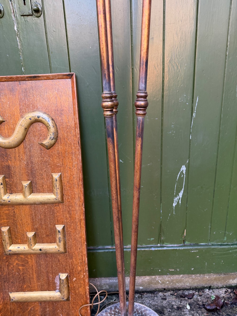 A pair of early 20th-century gilt metal torchiere floor lamps featuring fluted inverted cone shades and slender multi-stemmed stands supported by textured circular bases. View XI