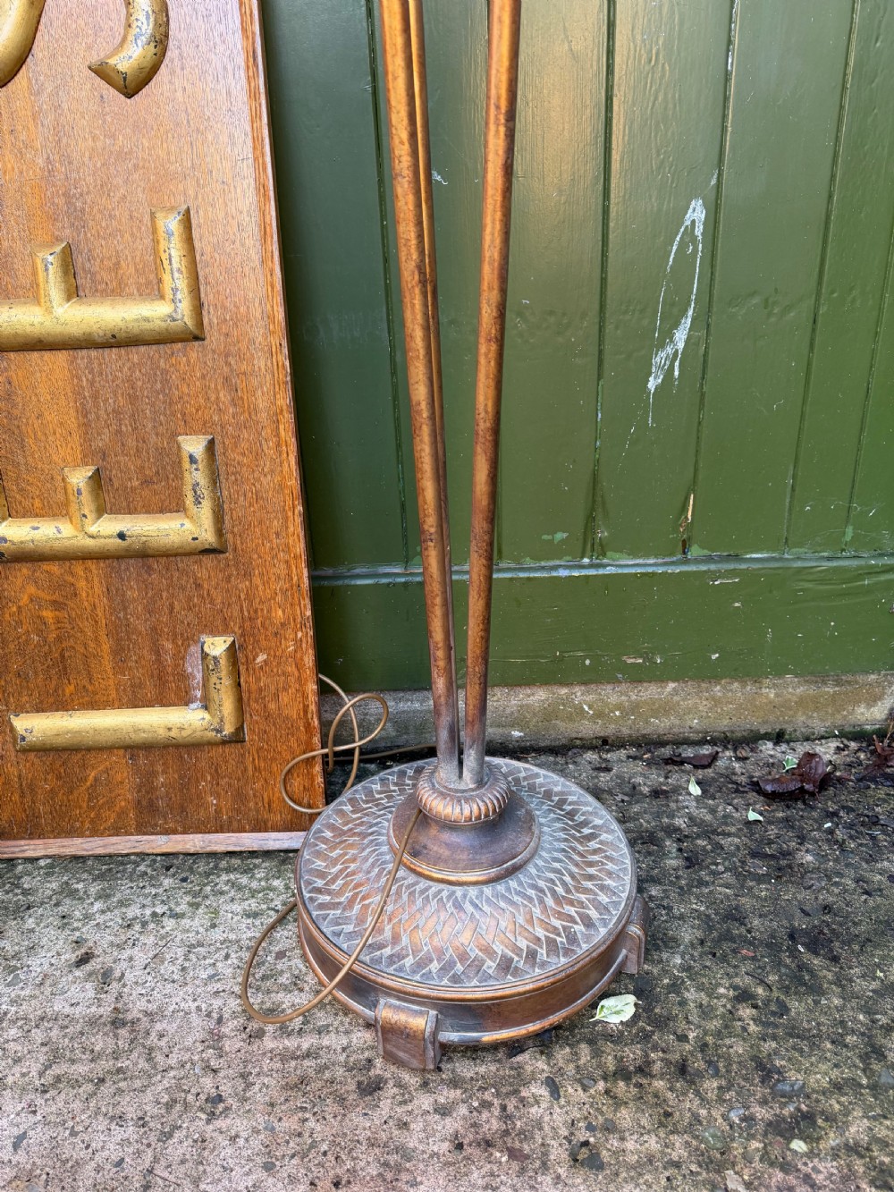 A pair of early 20th-century gilt metal torchiere floor lamps featuring fluted inverted cone shades and slender multi-stemmed stands supported by textured circular bases. View XII