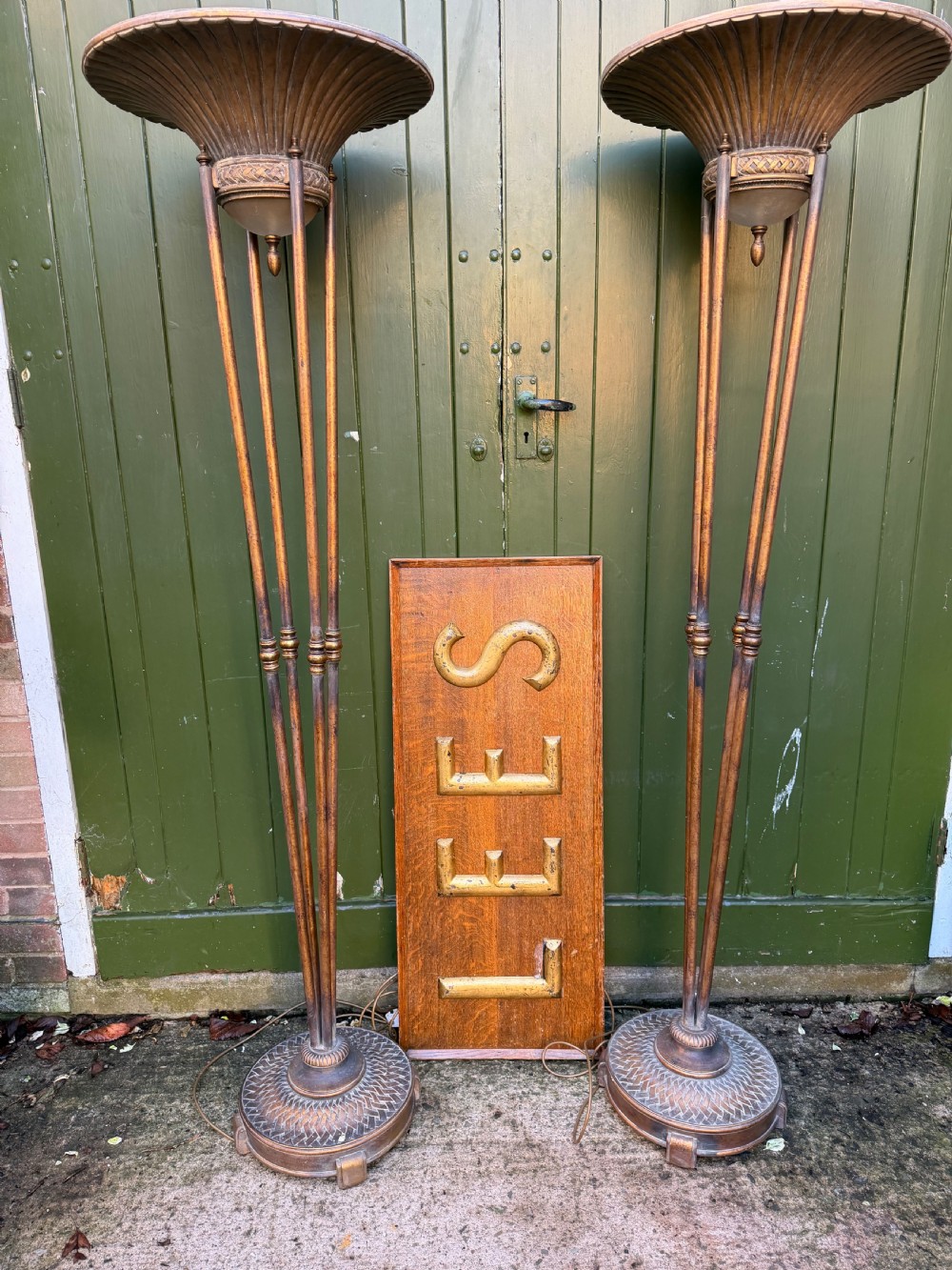 A pair of early 20th-century gilt metal torchiere floor lamps featuring fluted inverted cone shades and slender multi-stemmed stands supported by textured circular bases. View XIV