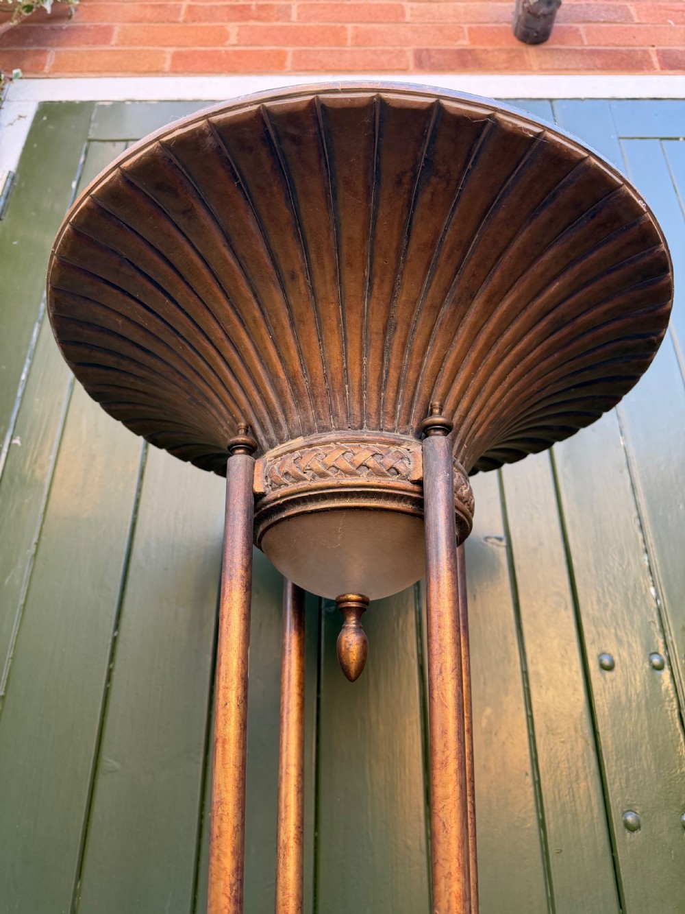 A pair of early 20th-century gilt metal torchiere floor lamps featuring fluted inverted cone shades and slender multi-stemmed stands supported by textured circular bases. View XVI