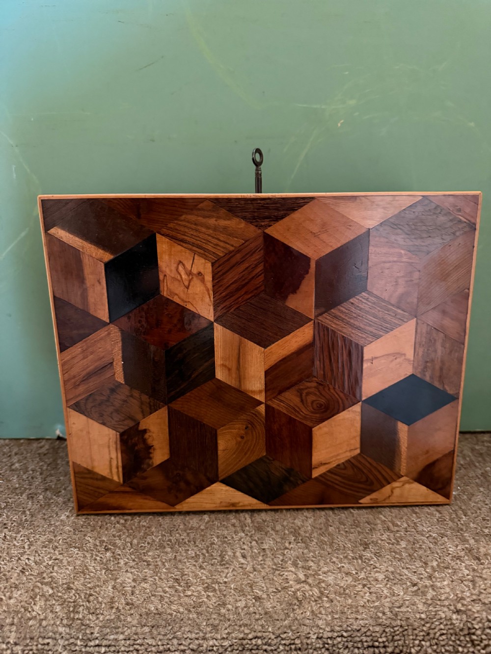 A nineteenth-century rectangular rosewood box featuring a geometric specimen wood parquetry lid and a central keyhole. View II