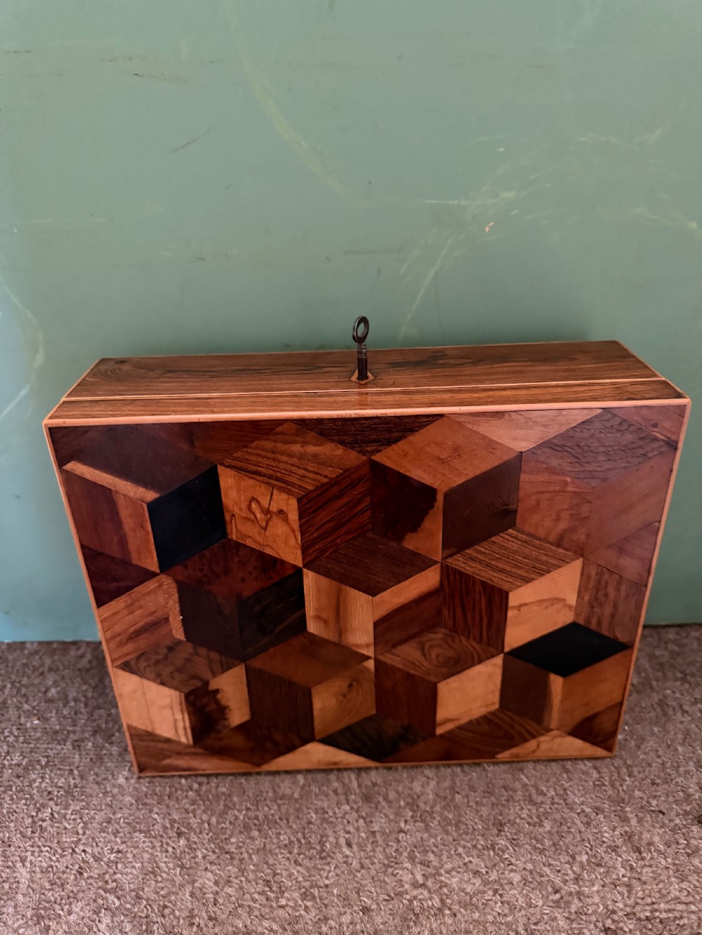 A nineteenth-century rectangular rosewood box featuring a geometric specimen wood parquetry lid and a central keyhole. View III