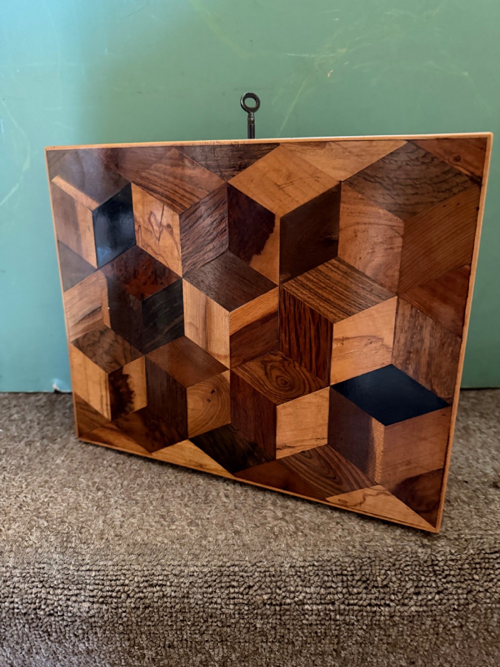 A nineteenth-century rectangular rosewood box featuring a geometric specimen wood parquetry lid and a central keyhole. View V