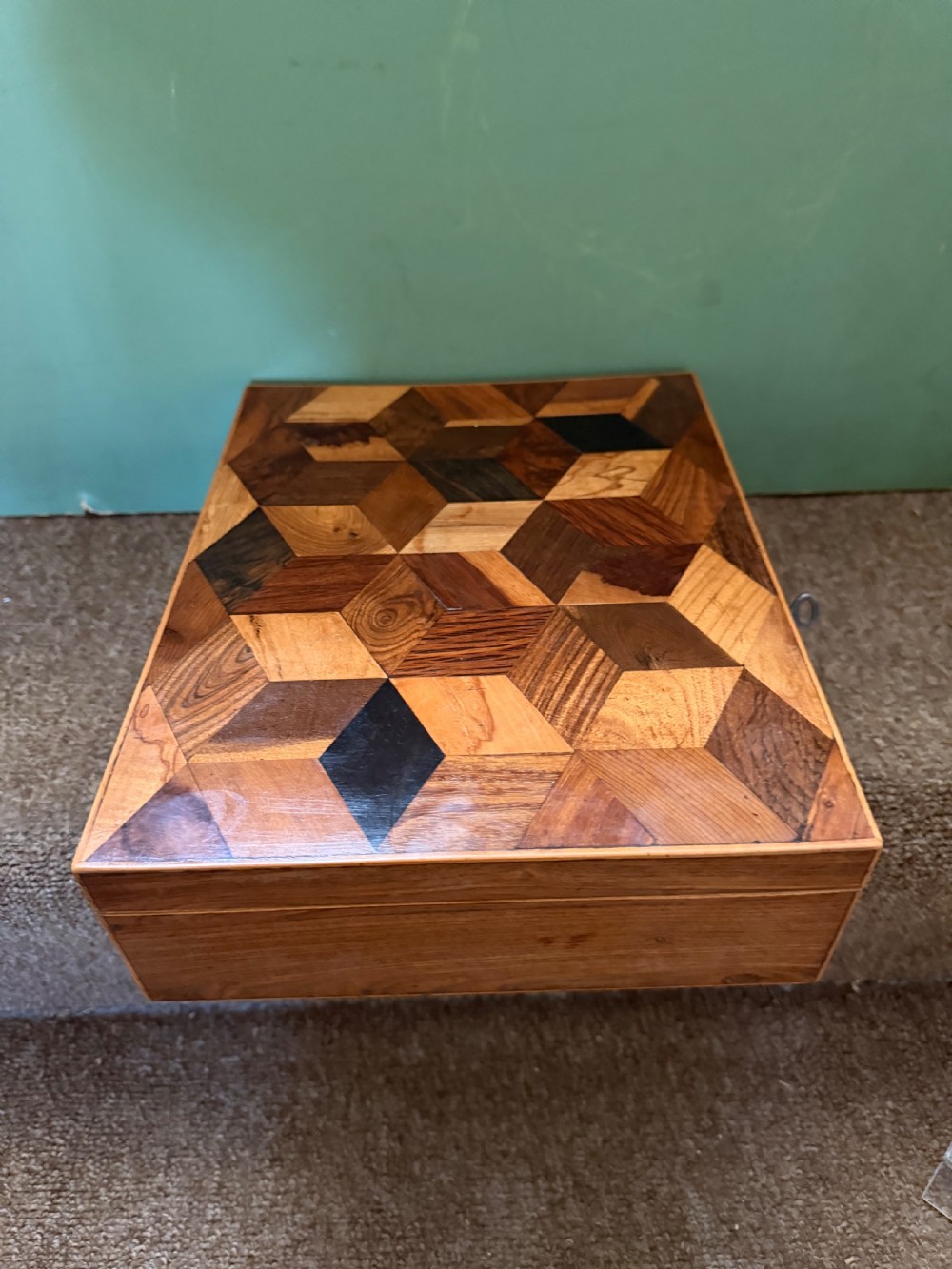 A nineteenth-century rectangular rosewood box featuring a geometric specimen wood parquetry lid and a central keyhole. View VII