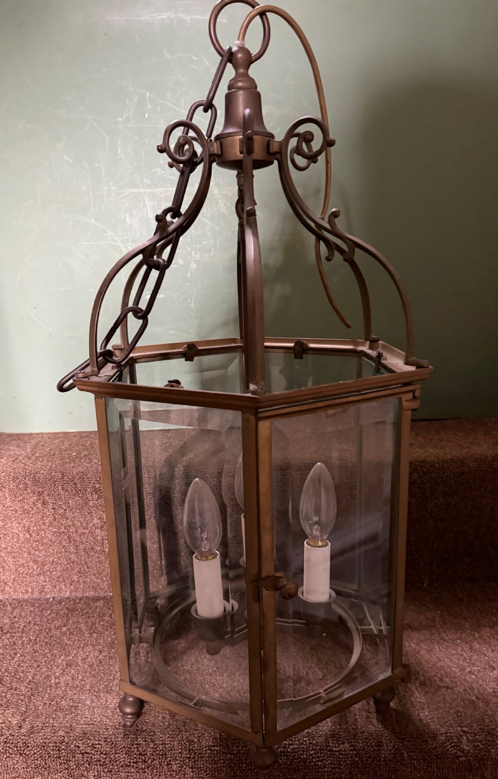 A late nineteenth-century hexagonal brass hanging lantern featuring clear glass panels, scrollwork canopy, and a three-light candle fitting. View III