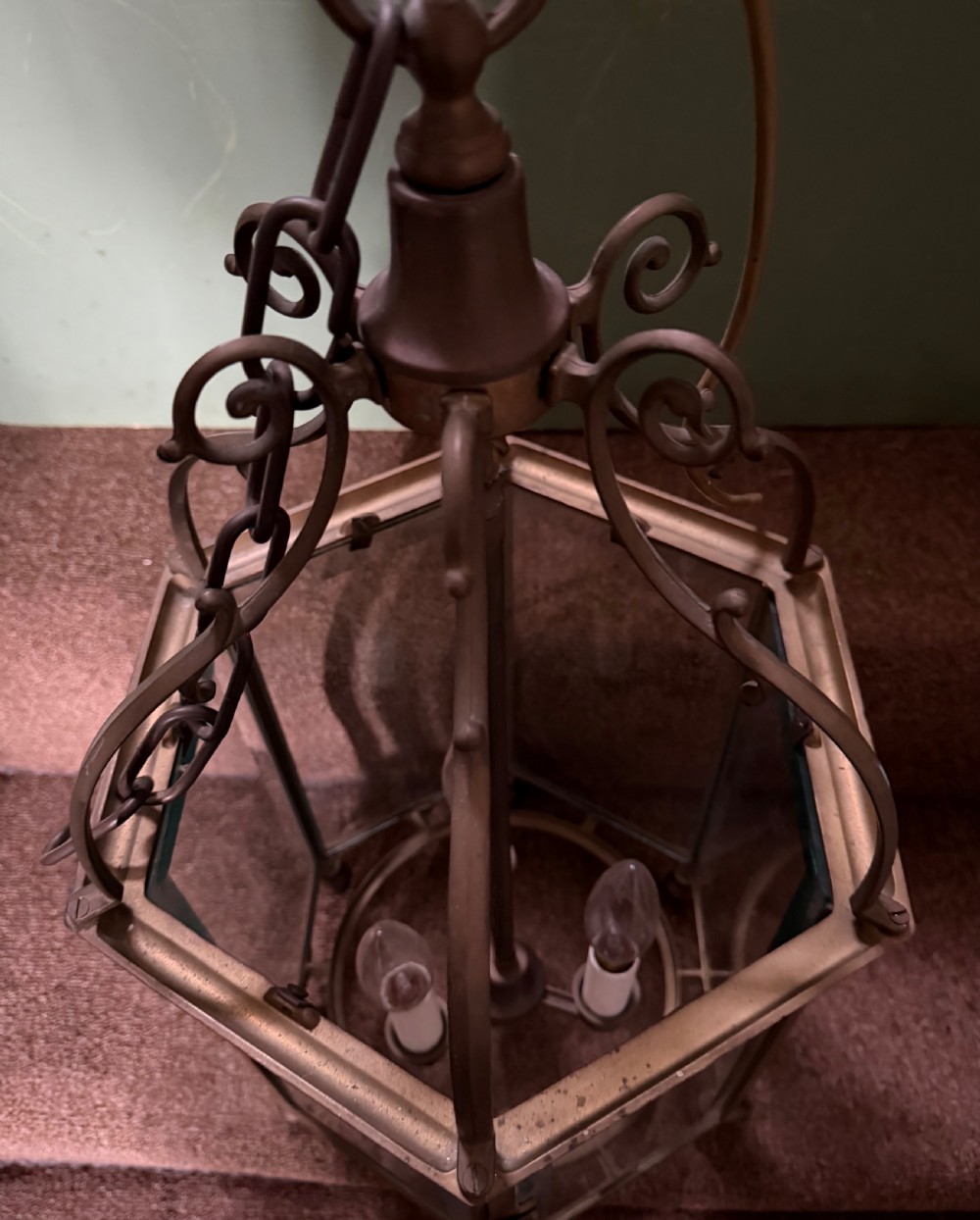 A late nineteenth-century hexagonal brass hanging lantern featuring clear glass panels, scrollwork canopy, and a three-light candle fitting. View VIII