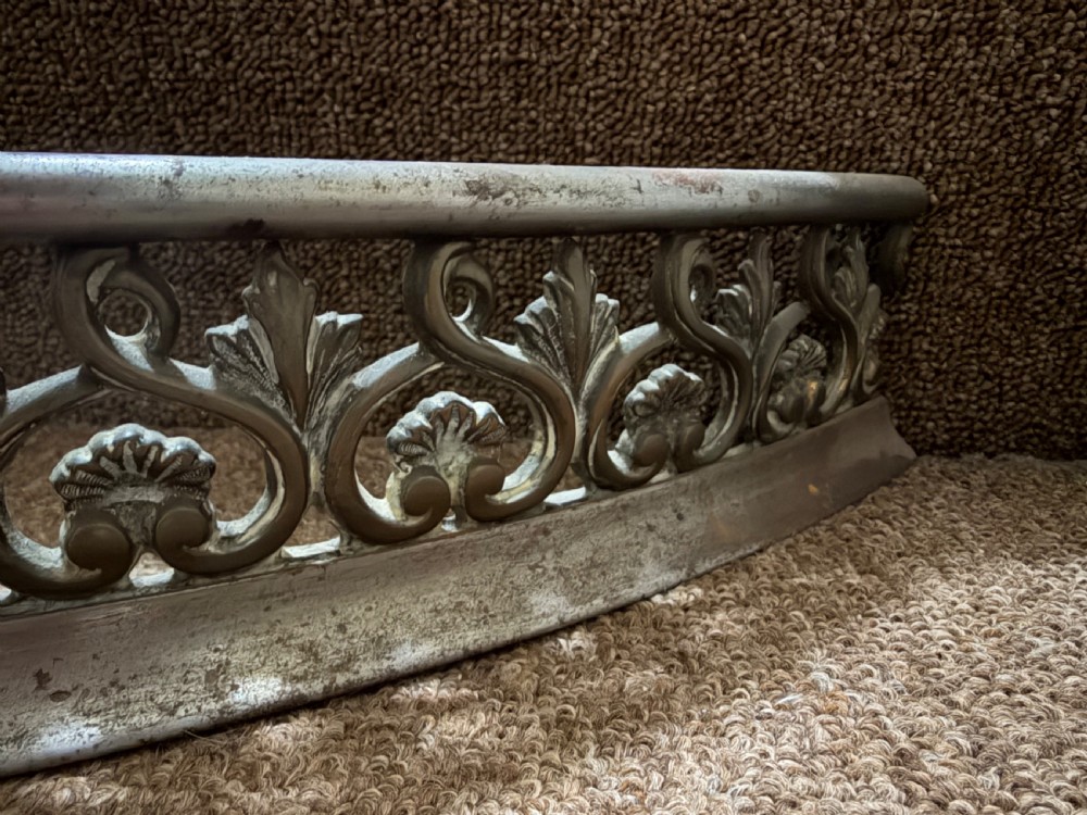 An early 19th-century curved steel fireplace curb featuring openwork Neoclassical cast scrollwork and palmette motifs. View III