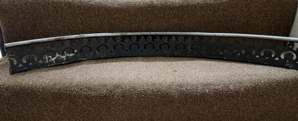 An early 19th-century curved steel fireplace curb featuring openwork Neoclassical cast scrollwork and palmette motifs. View IV