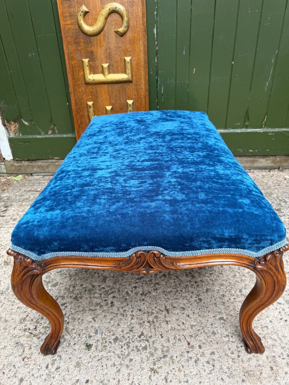 A mid-19th-century centre stool featuring carved walnut cabriole legs, carved aprons, and blue velvet upholstered top. View VII