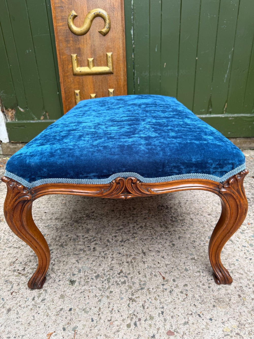 A mid-19th-century centre stool featuring carved walnut cabriole legs, carved aprons, and blue velvet upholstered top. View VIII