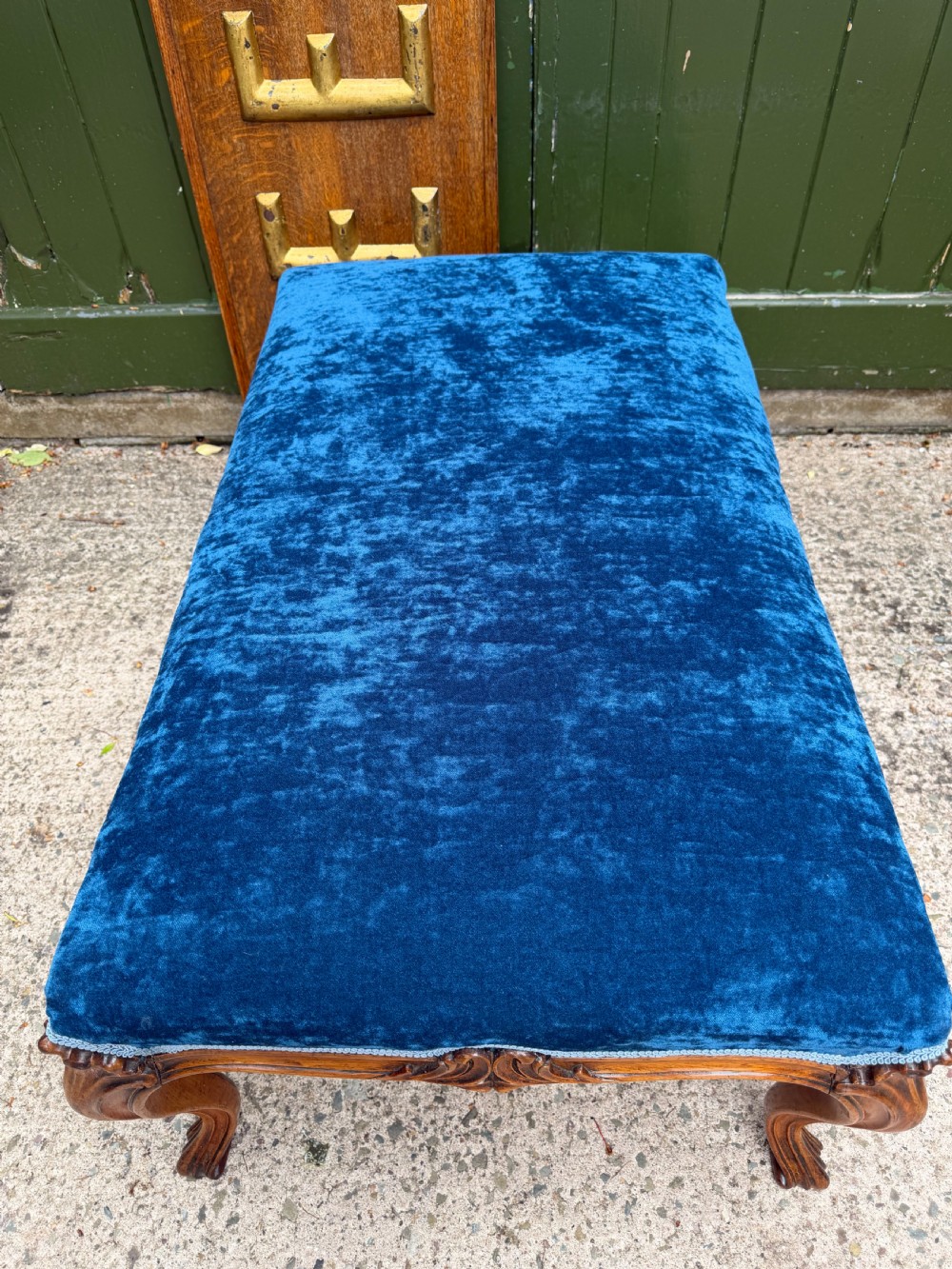 A mid-19th-century centre stool featuring carved walnut cabriole legs, carved aprons, and blue velvet upholstered top. View IX
