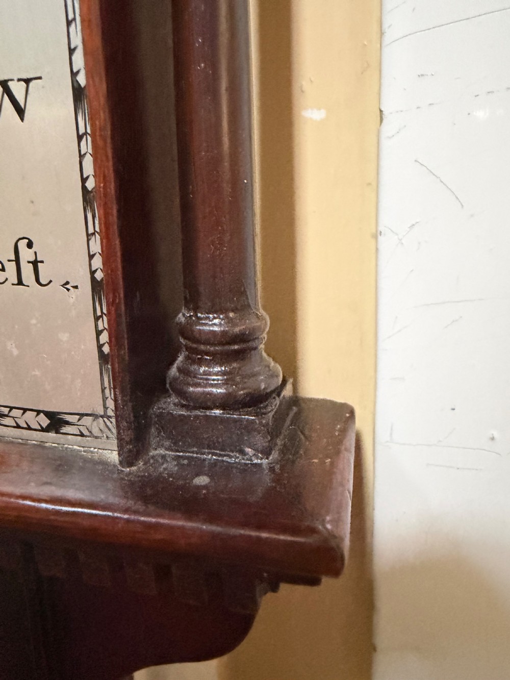 An eighteenth-century George III mahogany stick barometer with an architectural pediment and an engraved silvered dial. View X