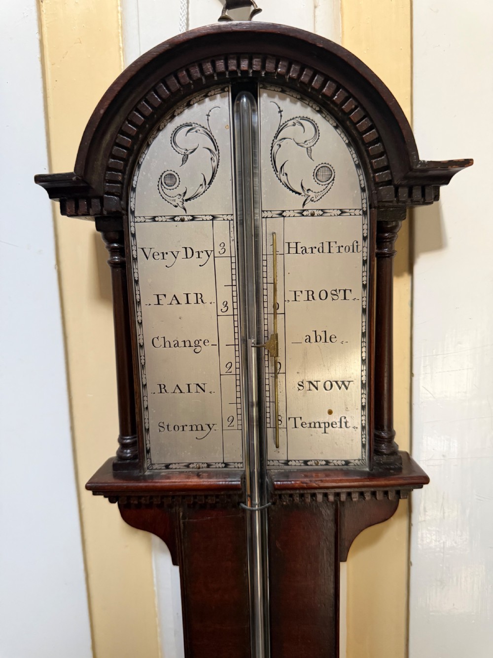 An eighteenth-century George III mahogany stick barometer with an architectural pediment and an engraved silvered dial. View XI