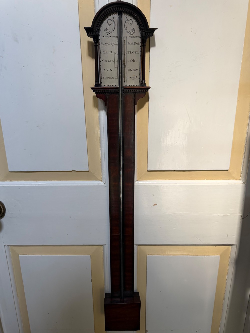 An eighteenth-century George III mahogany stick barometer with an architectural pediment and an engraved silvered dial. View XII