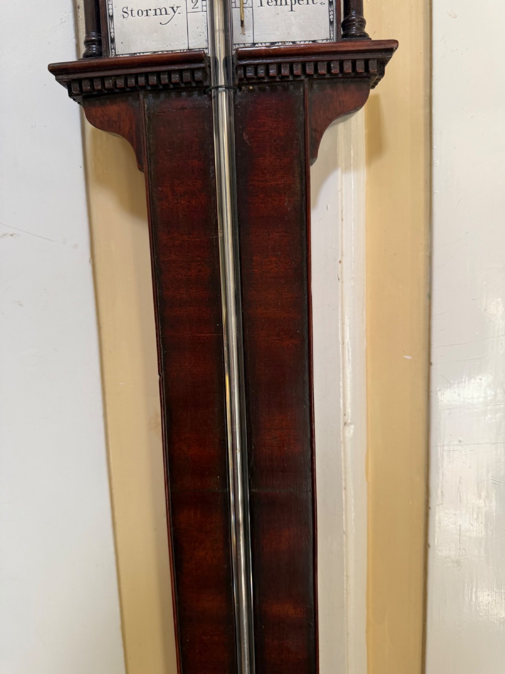 An eighteenth-century George III mahogany stick barometer with an architectural pediment and an engraved silvered dial. View XIV