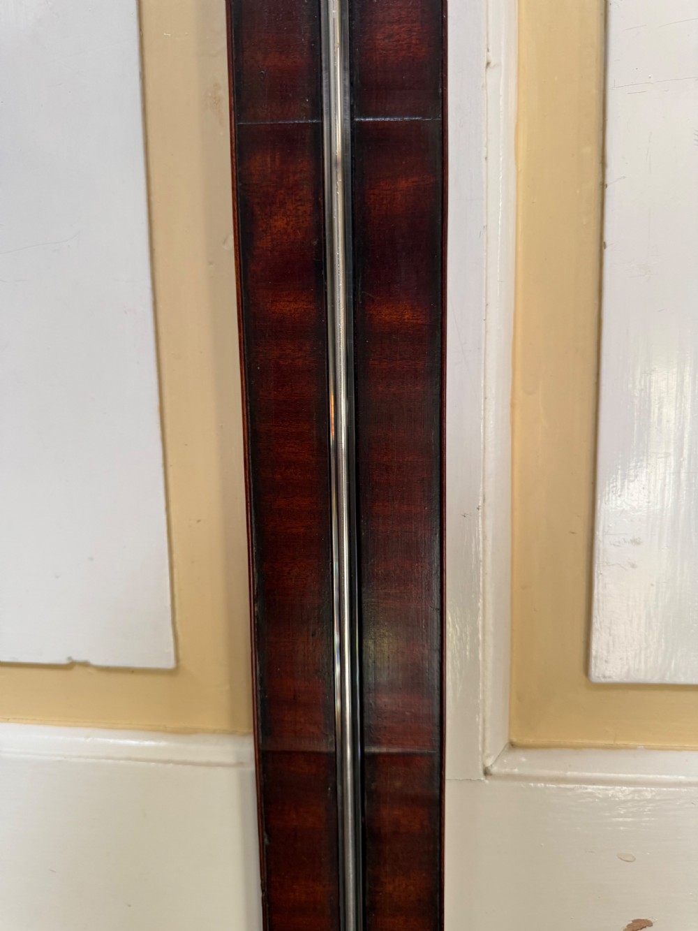 An eighteenth-century George III mahogany stick barometer with an architectural pediment and an engraved silvered dial. View XV
