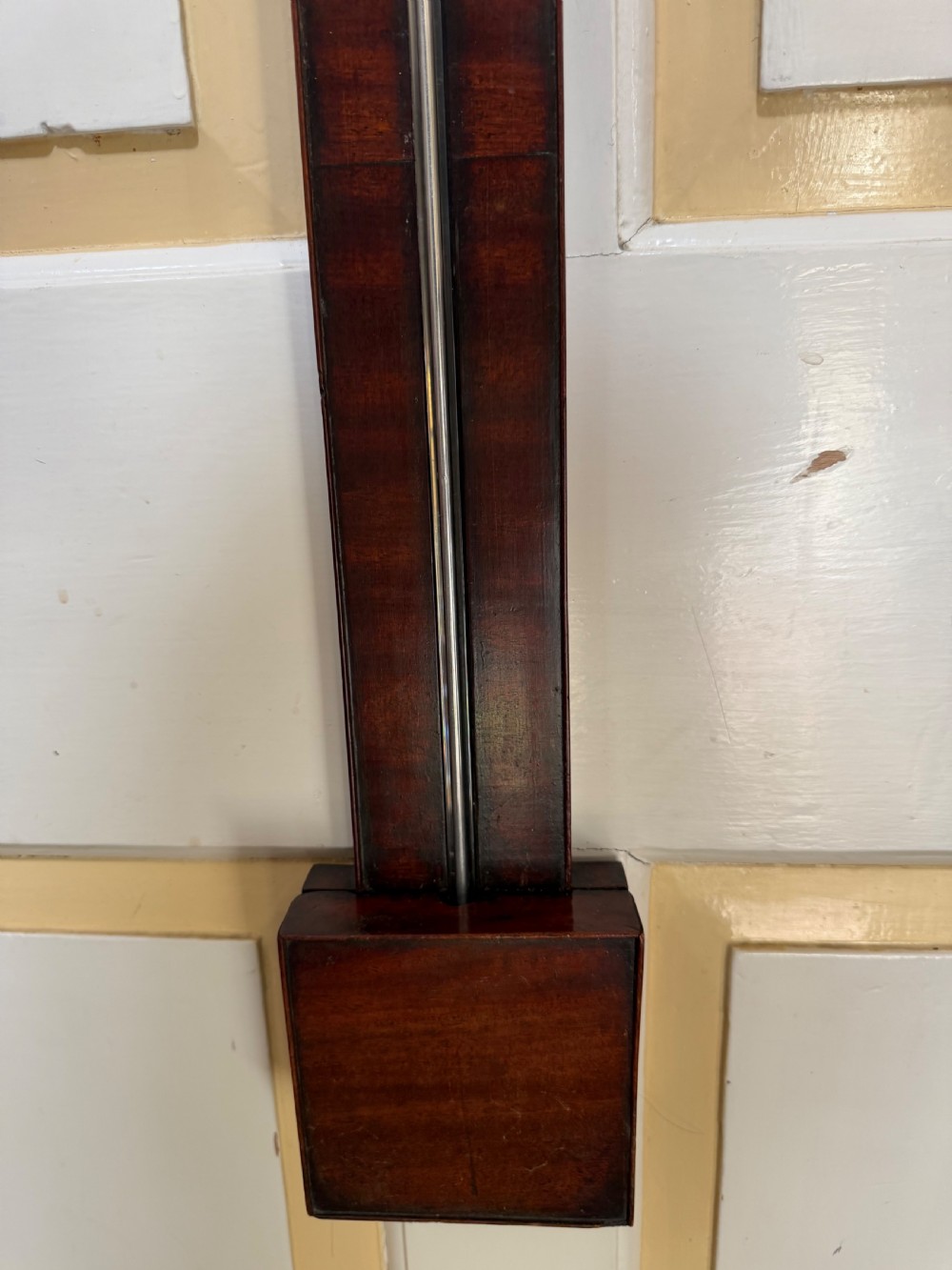 An eighteenth-century George III mahogany stick barometer with an architectural pediment and an engraved silvered dial. View XVI