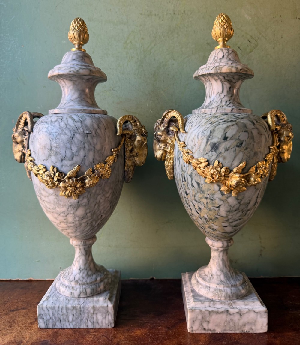 A pair of late 19th-century French Louis XVI style Campan vert marble urns adorned with gilt bronze ram head handles, floral swags, and pinecone finials. View III