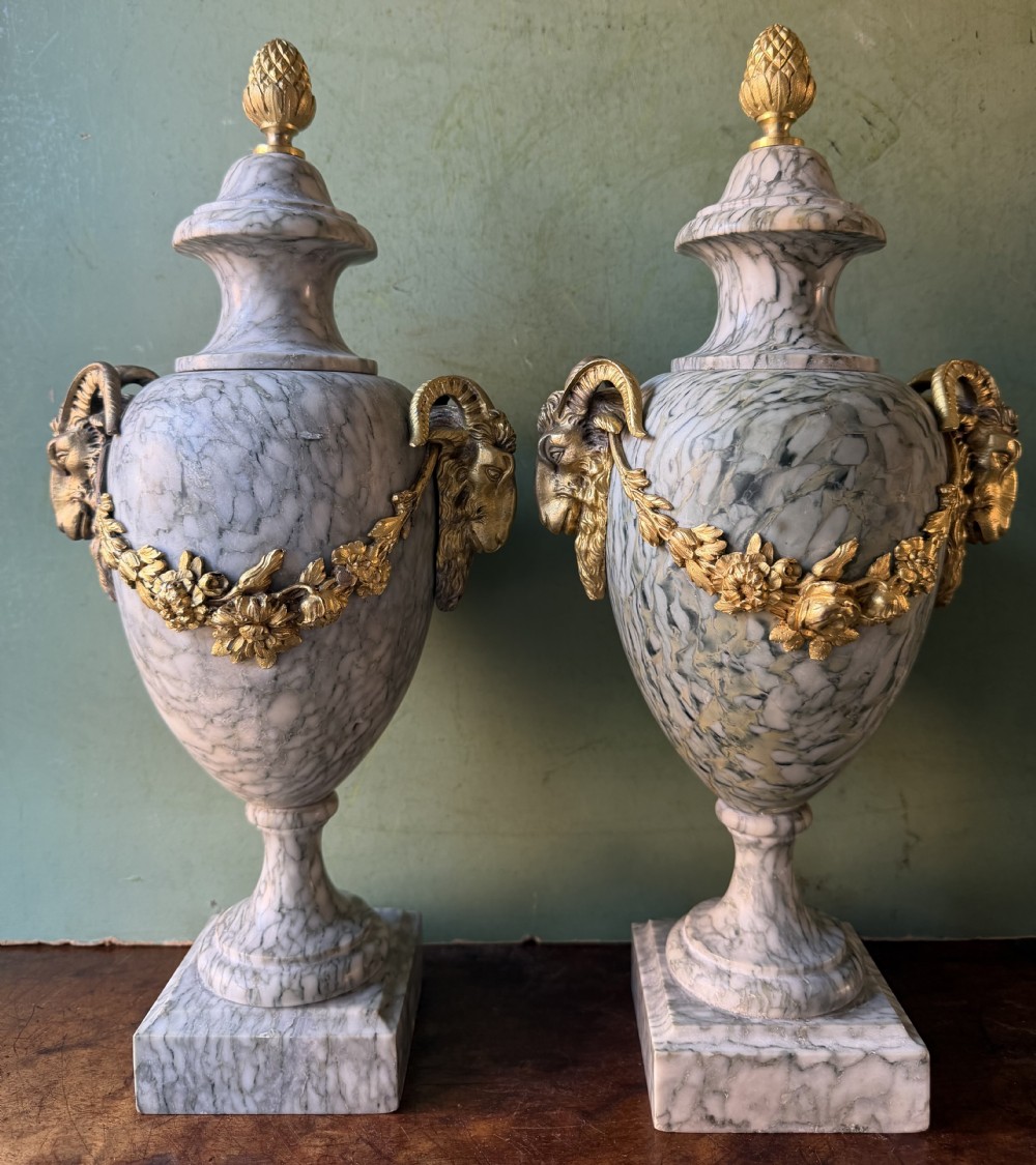 A pair of late 19th-century French Louis XVI style Campan vert marble urns adorned with gilt bronze ram head handles, floral swags, and pinecone finials. View XIV