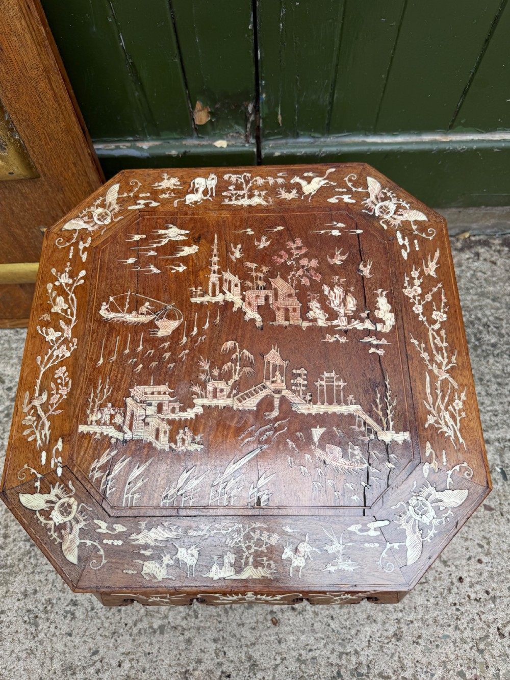 A late 19th-century Chinese dark hardwood occasional table decorated with detailed bone inlay landscape scenes, featuring cabriole legs and a carved apron. View III