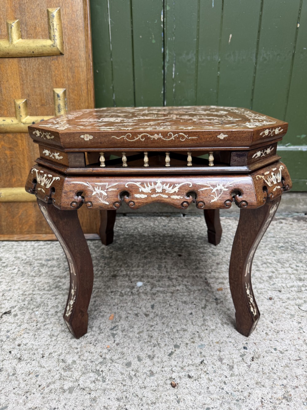 A late 19th-century Chinese dark hardwood occasional table decorated with detailed bone inlay landscape scenes, featuring cabriole legs and a carved apron. View V