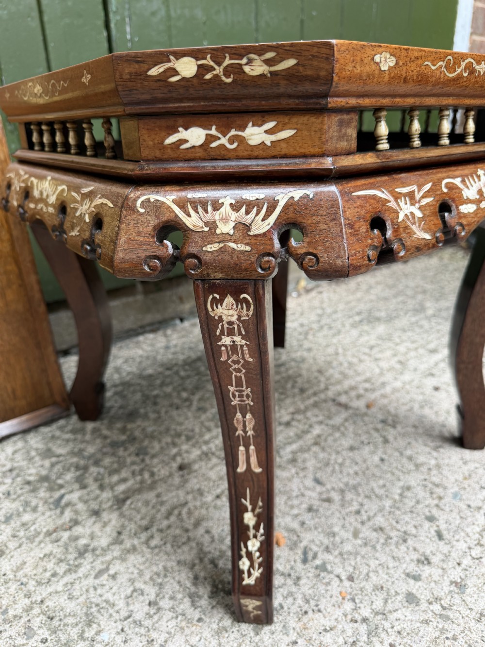 A late 19th-century Chinese dark hardwood occasional table decorated with detailed bone inlay landscape scenes, featuring cabriole legs and a carved apron. View VI