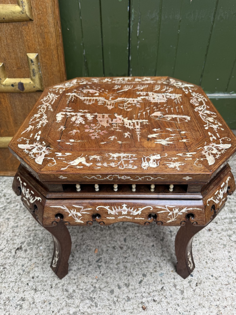 A late 19th-century Chinese dark hardwood occasional table decorated with detailed bone inlay landscape scenes, featuring cabriole legs and a carved apron. View IX