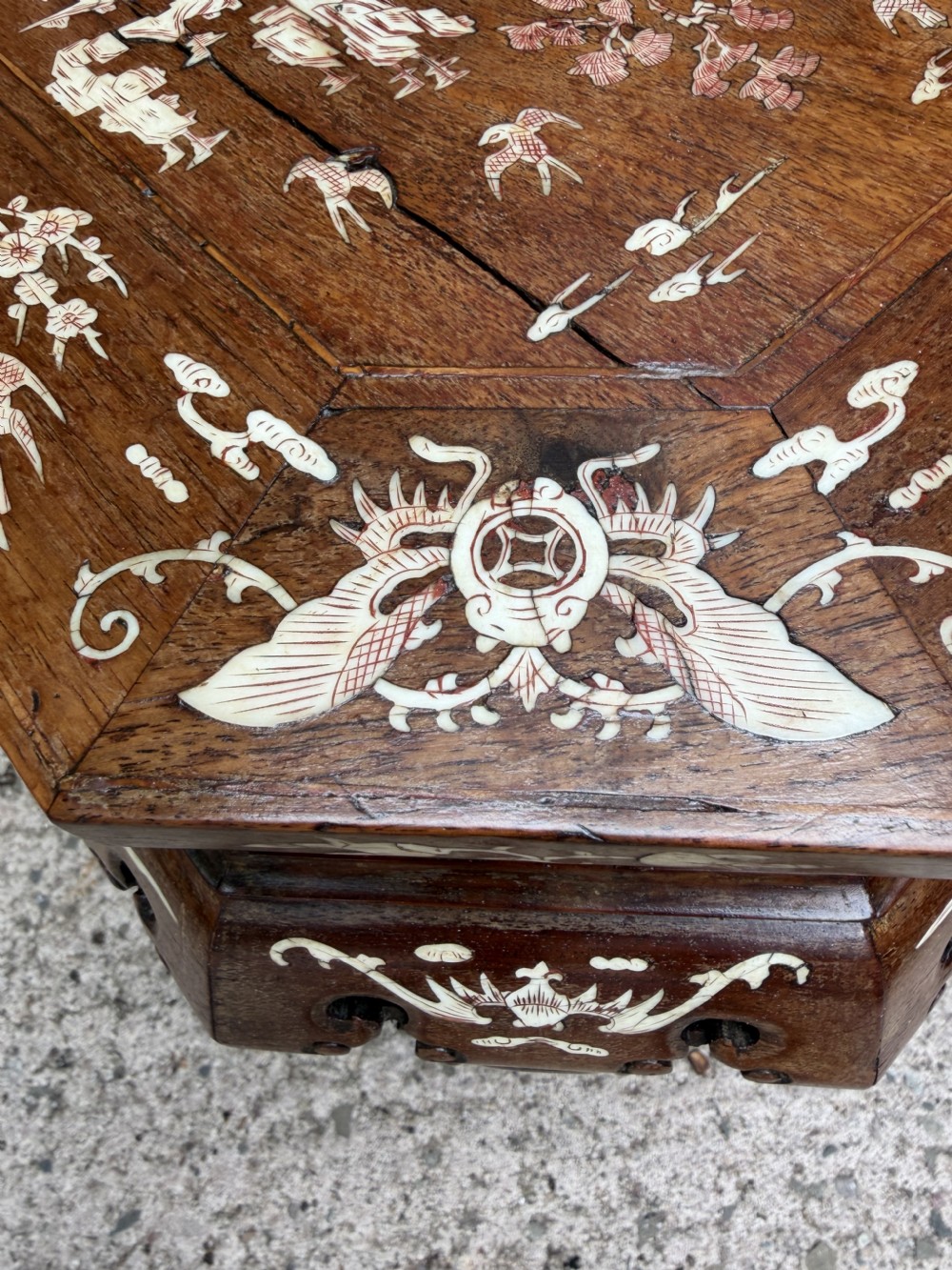 A late 19th-century Chinese dark hardwood occasional table decorated with detailed bone inlay landscape scenes, featuring cabriole legs and a carved apron. View X