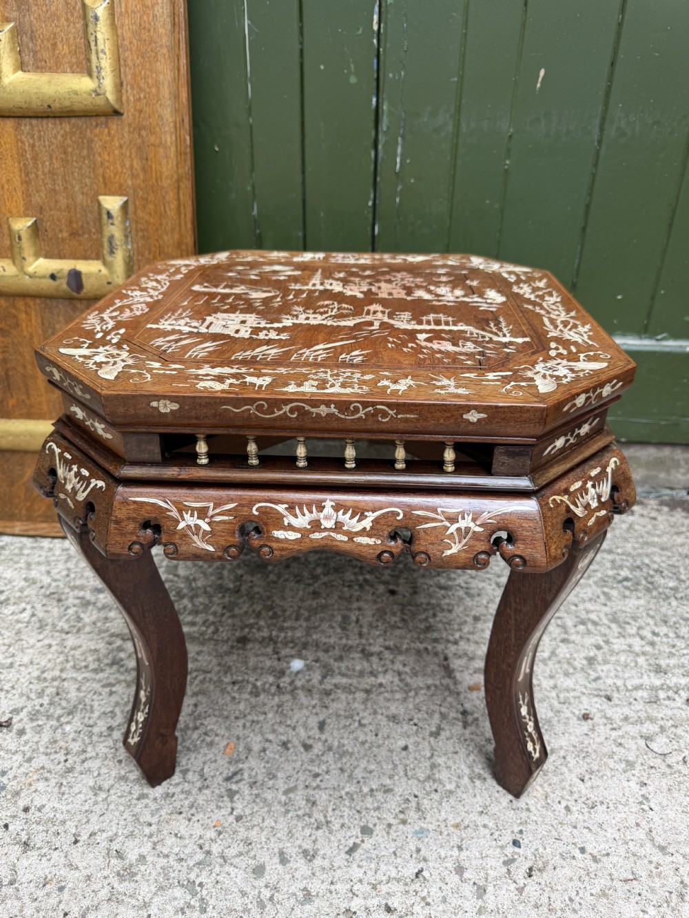 A late 19th-century Chinese dark hardwood occasional table decorated with detailed bone inlay landscape scenes, featuring cabriole legs and a carved apron. View XIII