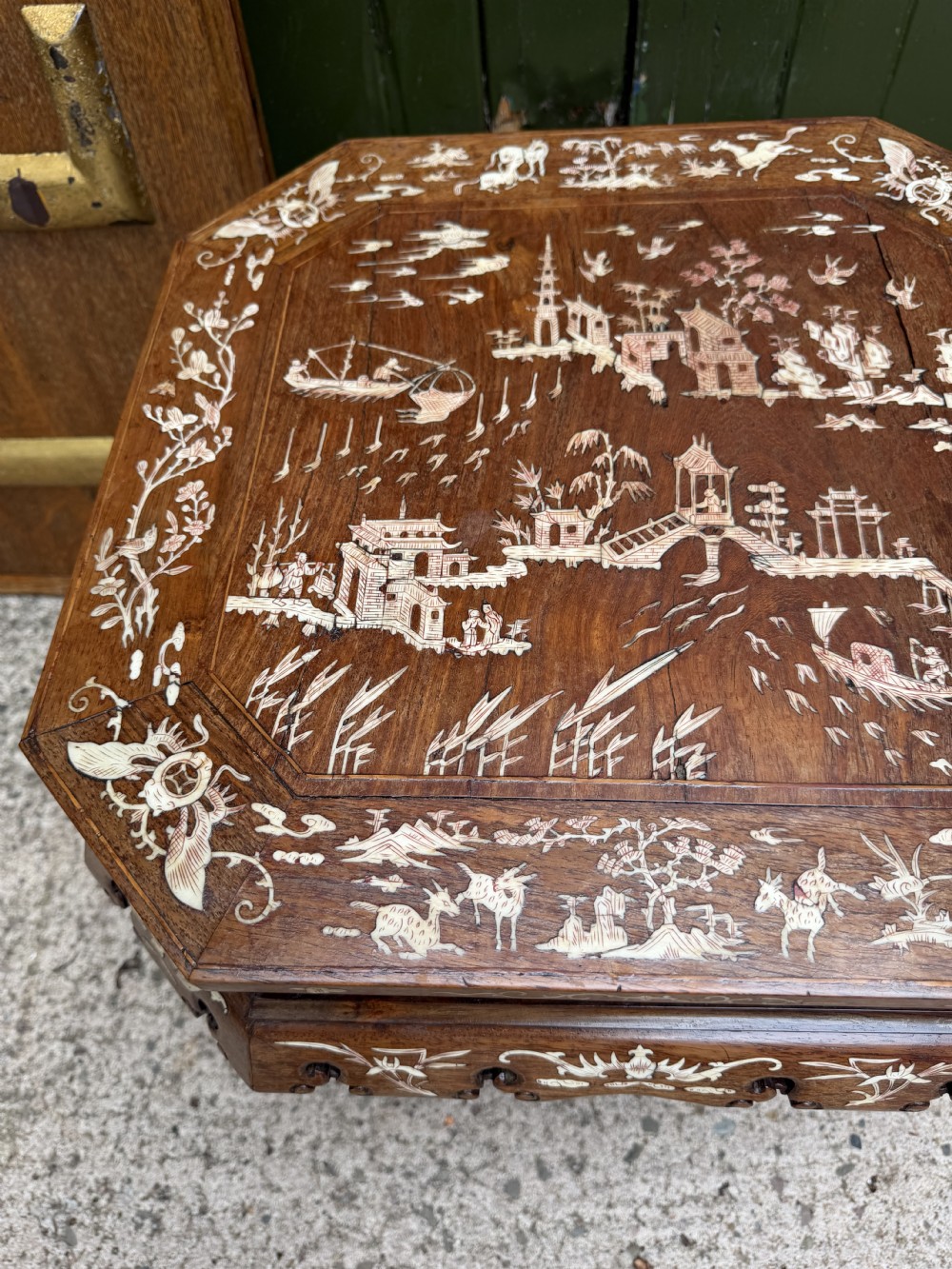 A late 19th-century Chinese dark hardwood occasional table decorated with detailed bone inlay landscape scenes, featuring cabriole legs and a carved apron. View XV