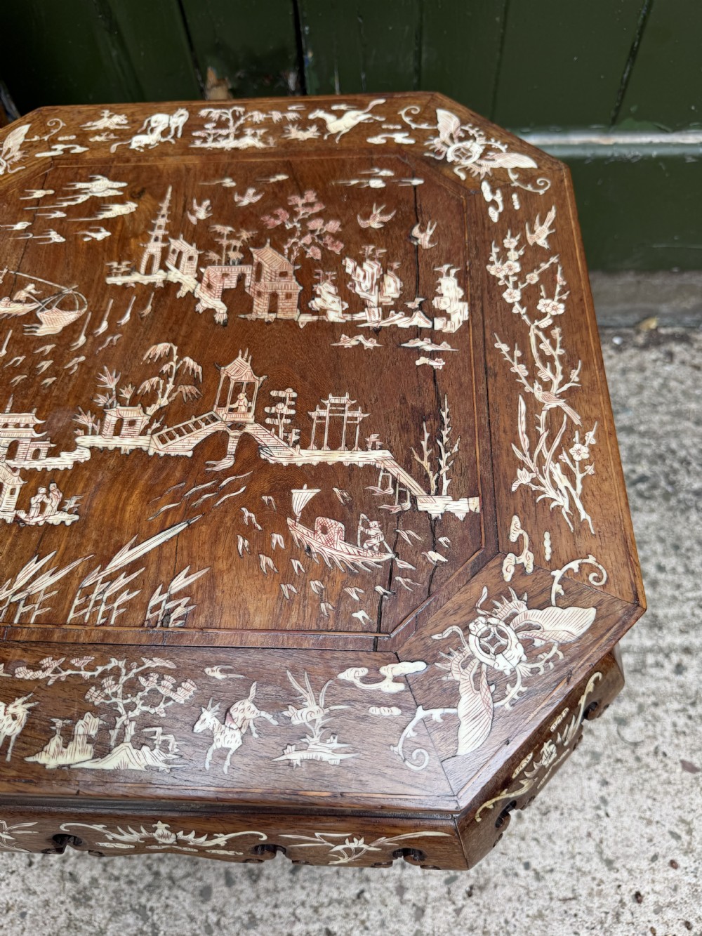 A late 19th-century Chinese dark hardwood occasional table decorated with detailed bone inlay landscape scenes, featuring cabriole legs and a carved apron. View XVI