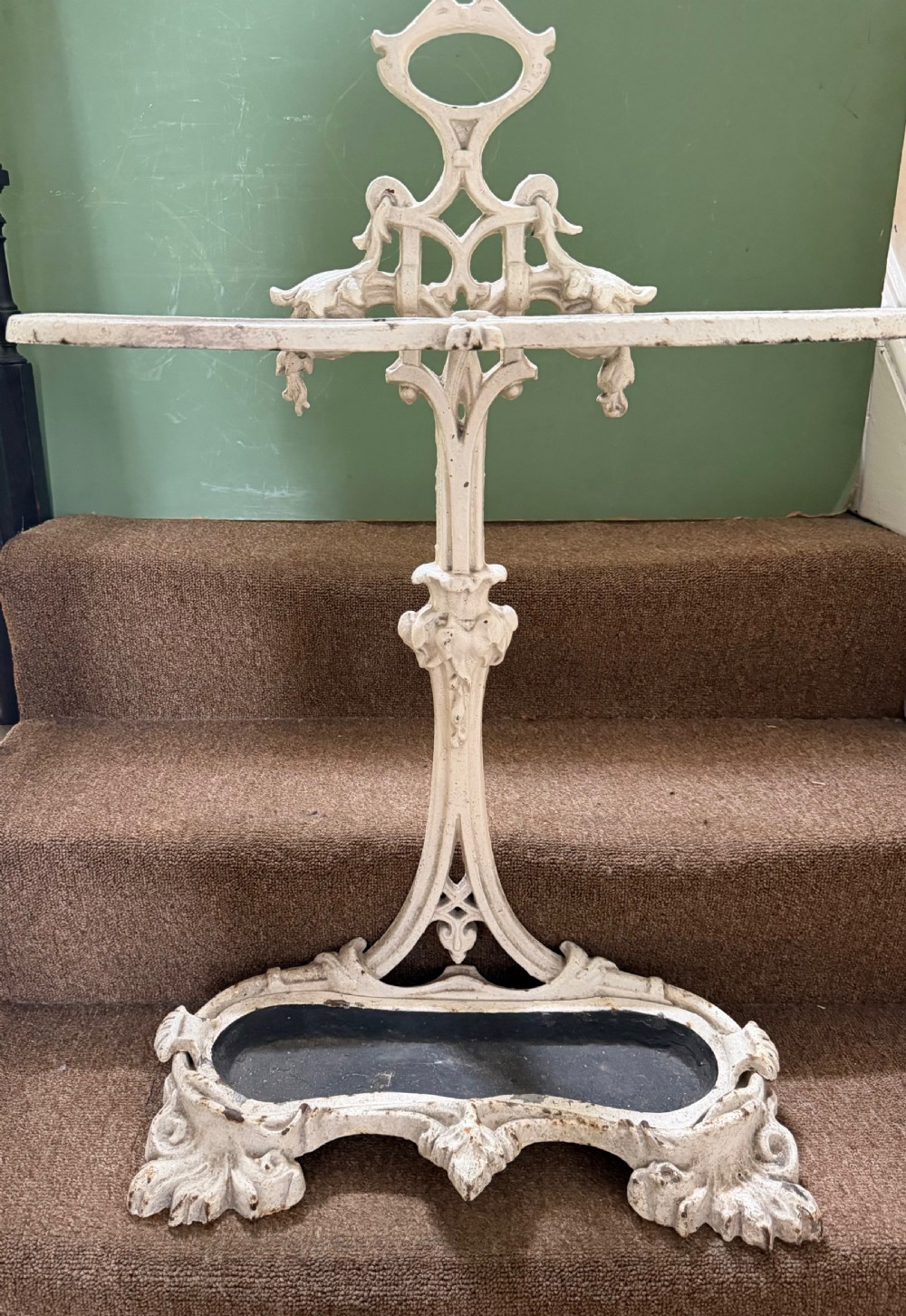 A mid 19th-century off-white painted cast-iron stick and umbrella stand with ornate tracery and a removable dark drip tray base. View II
