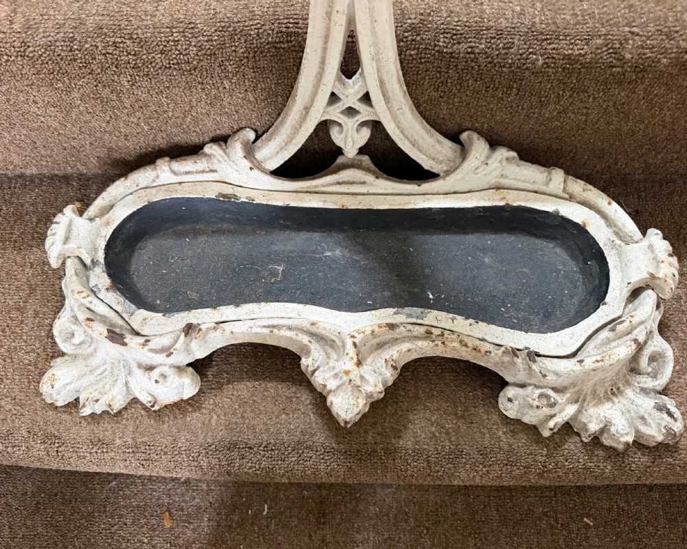 A mid 19th-century off-white painted cast-iron stick and umbrella stand with ornate tracery and a removable dark drip tray base. View V