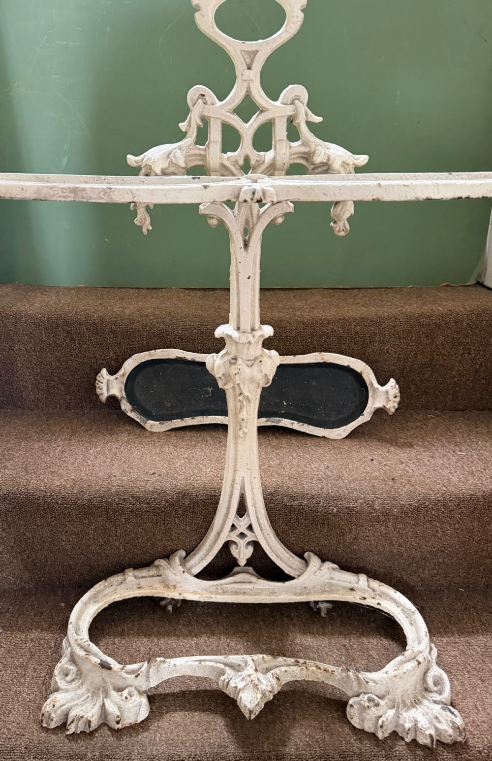 A mid 19th-century off-white painted cast-iron stick and umbrella stand with ornate tracery and a removable dark drip tray base. View VII