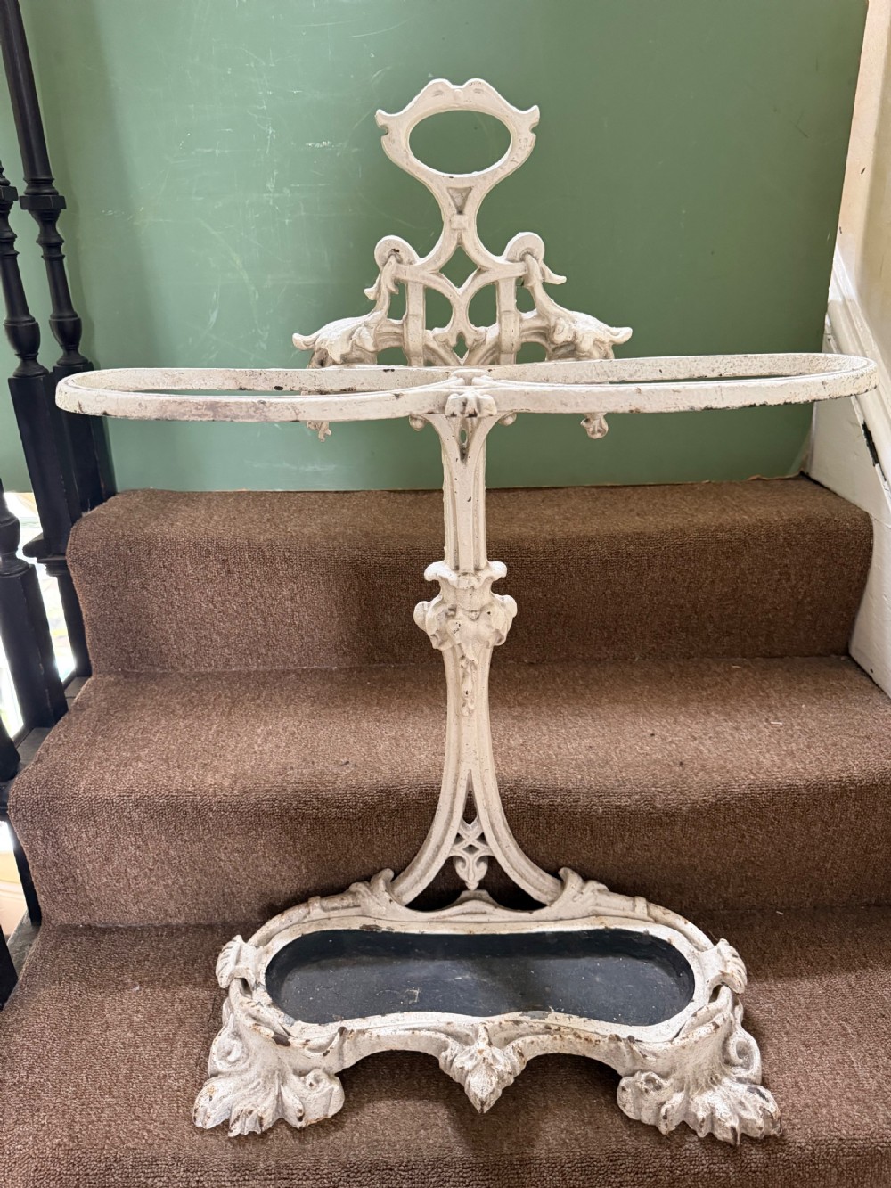 A mid 19th-century off-white painted cast-iron stick and umbrella stand with ornate tracery and a removable dark drip tray base. View XI
