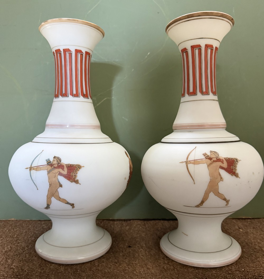 A pair of white opaline glass vases featuring flared necks decorated with orange Greek key patterns and baluster bodies painted with classical Grecian warrior figures. View III