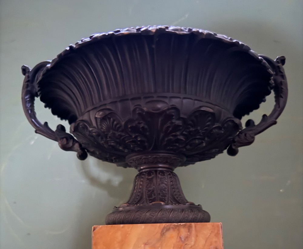 A pair of early 19th-century French Charles X dark bronze tazze with scrolling handles set upon yellow Siena marble plinth bases. View IV