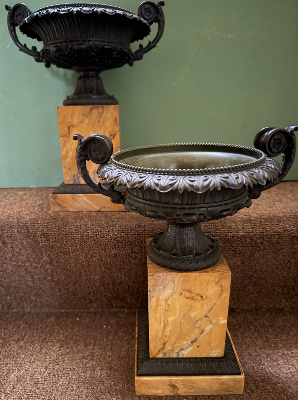 A pair of early 19th-century French Charles X dark bronze tazze with scrolling handles set upon yellow Siena marble plinth bases. View VI
