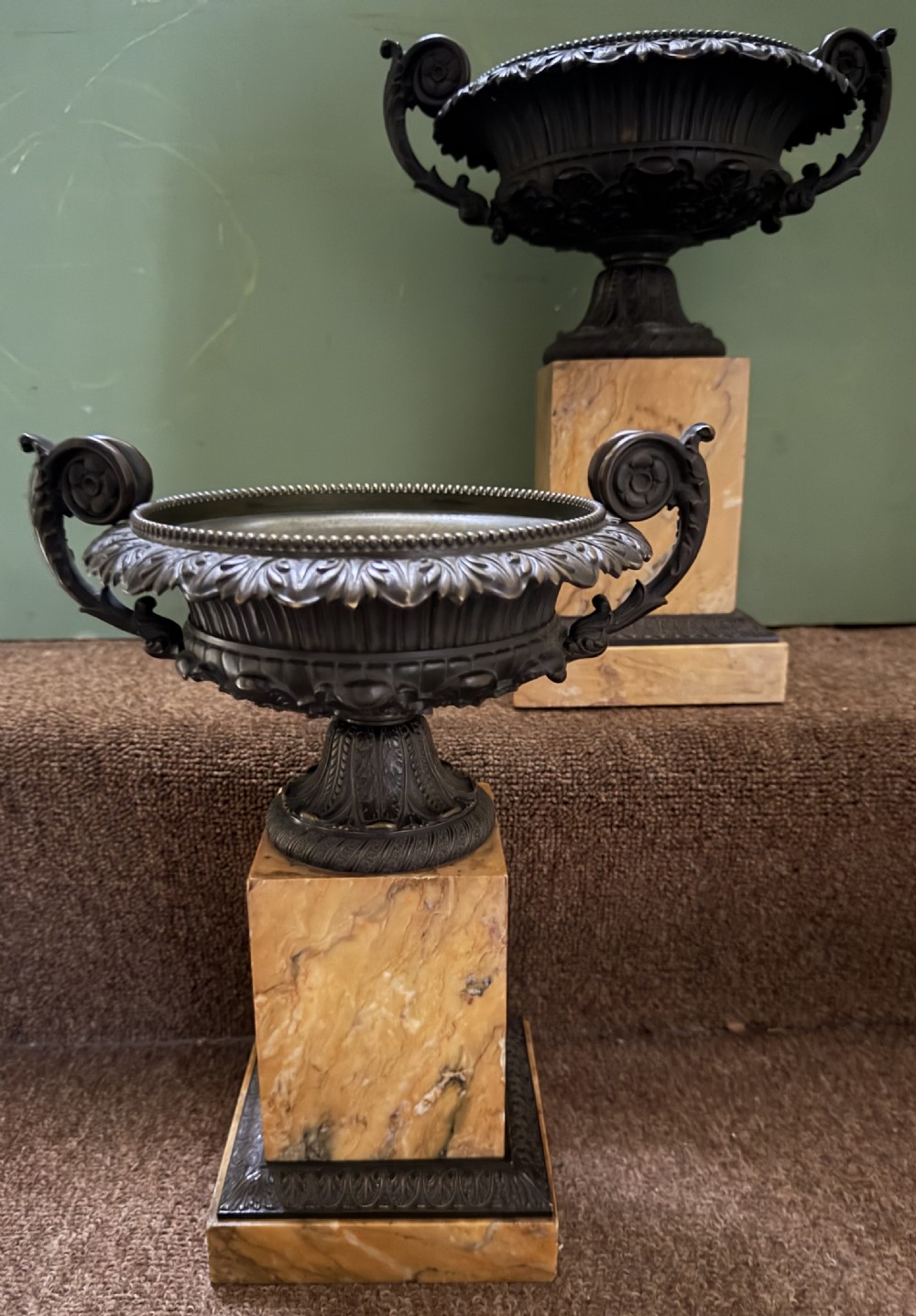 A pair of early 19th-century French Charles X dark bronze tazze with scrolling handles set upon yellow Siena marble plinth bases. View XV