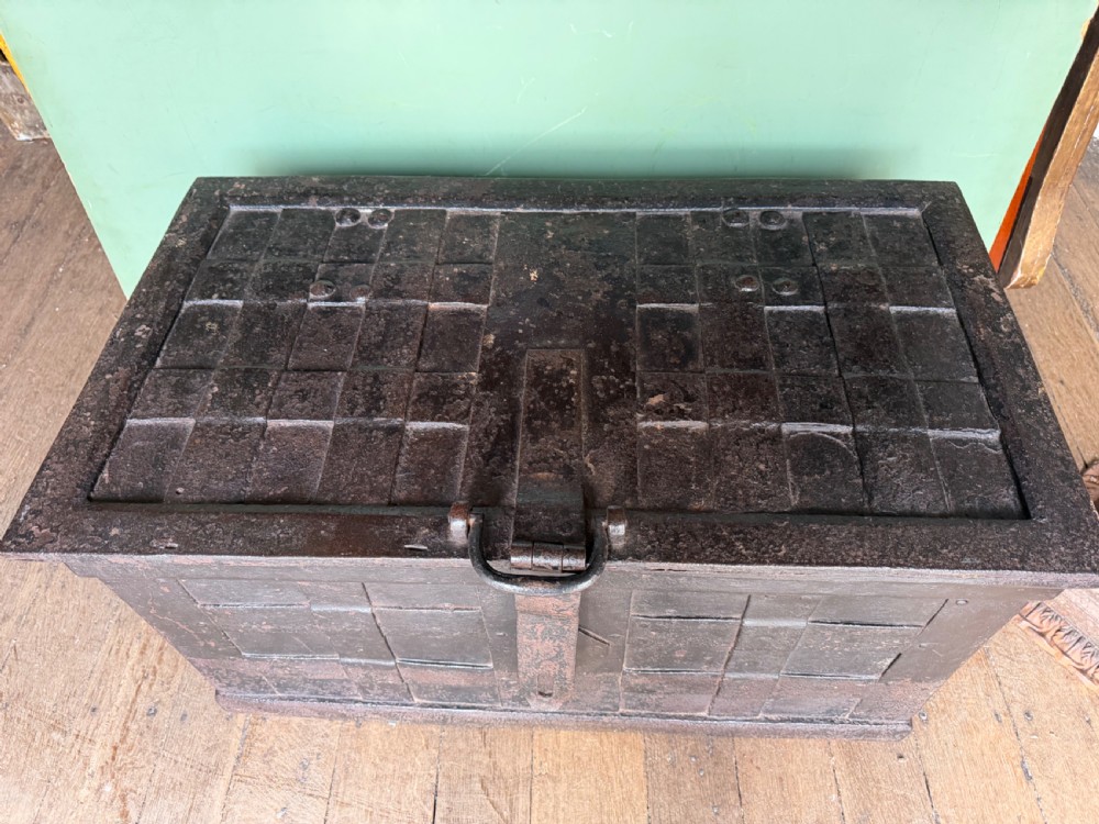 A rectangular late seventeenth-century wrought iron strongbox with criss-crossing riveted bands and a heavy central iron locking hasp. View III